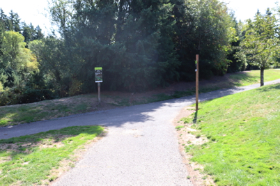 Paved trail junction with directional signage